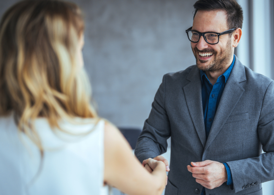 Portrait of cheerful young manager handshake with new employee